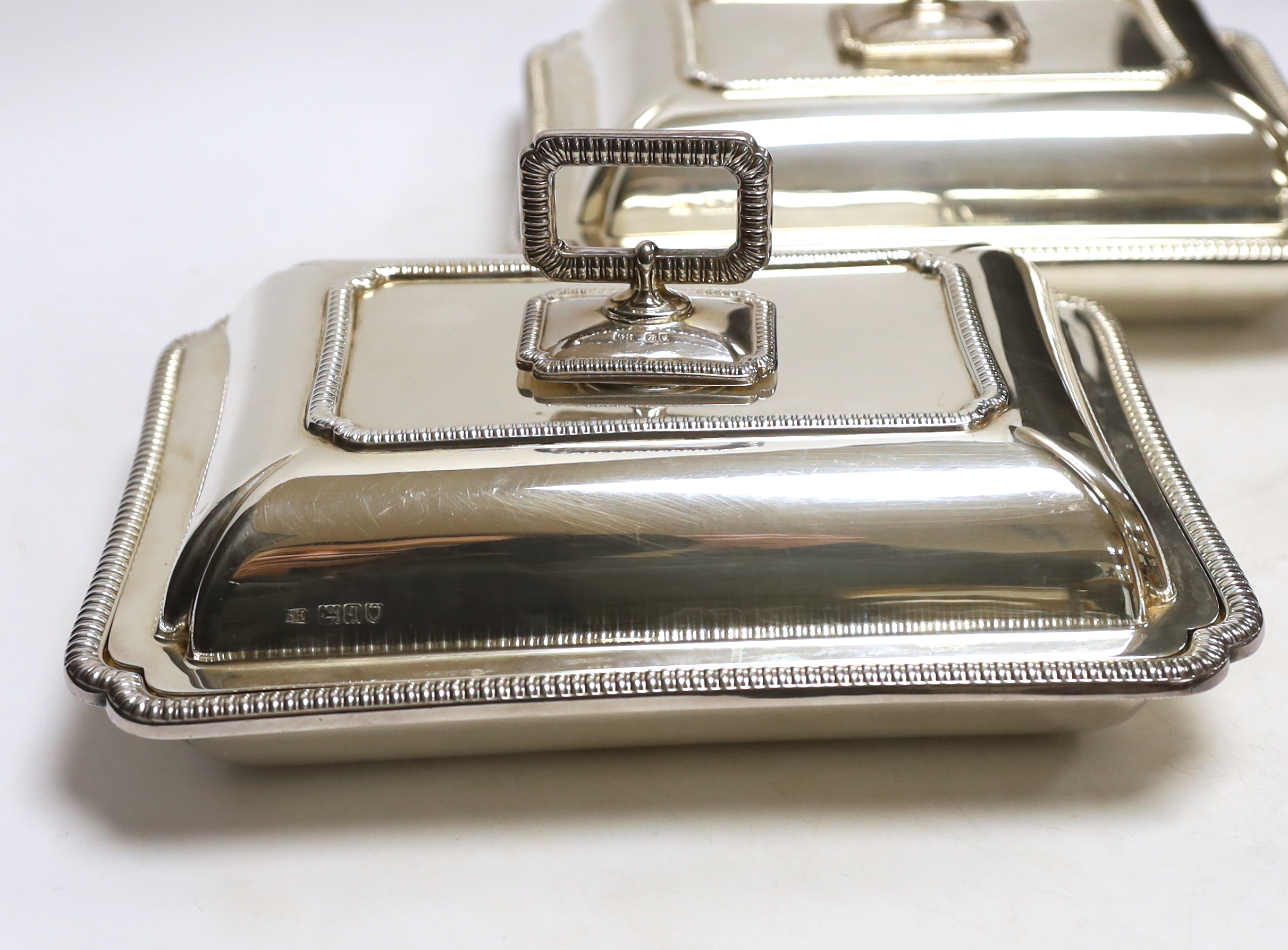 A pair of George V silver rectangular entrée dishes with covers and handles, by George Howson